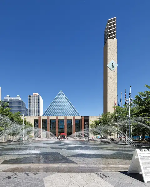 Edmonton City Hall's glass pyramid and clock tower behind the fountains of Sir Winston Churchill Square