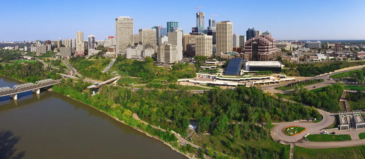 Aerial view of the North Saskatchewan River, the green river valley and downtown Edmonton with the Alberta Legislature grounds