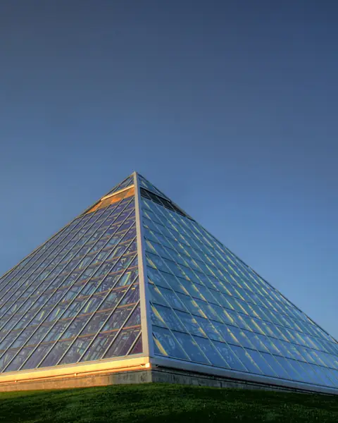 Glass pyramid of the Muttart Conservatory glowing in late-day light in Edmonton
